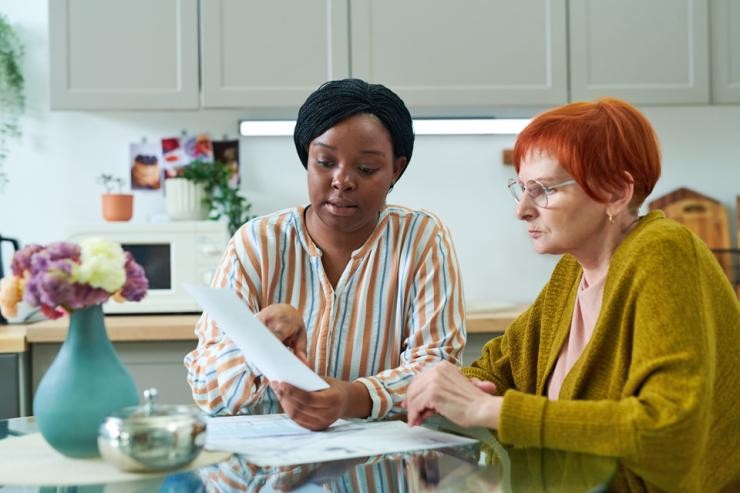 Beratungssituation aus dem Case Management Studierende erklärt einer unterstützungsbedürftigen Frau ein Antragsformular